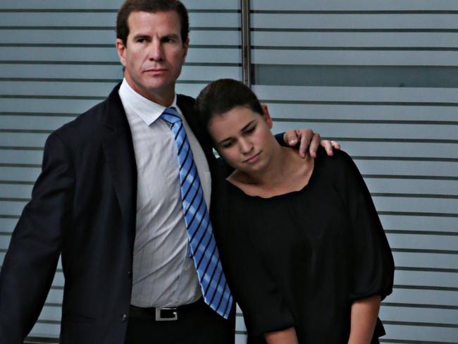 Matthew Perrin hugs his daughter outside court. Pic Annette Dew