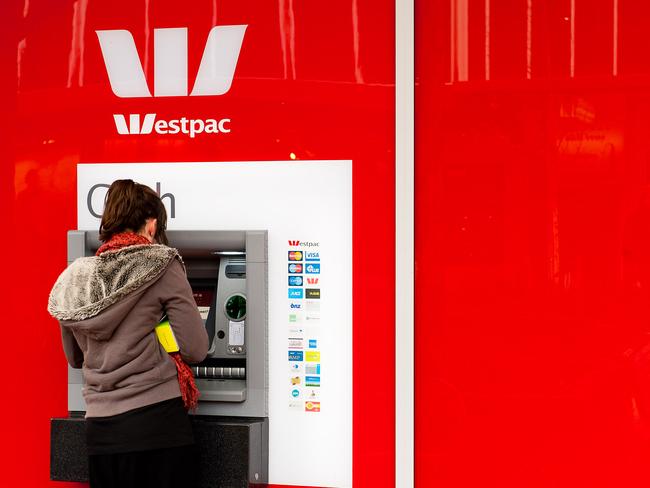 A woman uses a Westpac Banking Corp. automated teller machine (ATM) at Cuba Mall in downtown Wellington, New Zealand, on Wednesday, July 13, 2011. New Zealand's first quarter GDP, which includes the effects of the deadly February earthquake, will be released tomorrow after being delayed twice. Photographer: Mark Coote/Bloomberg