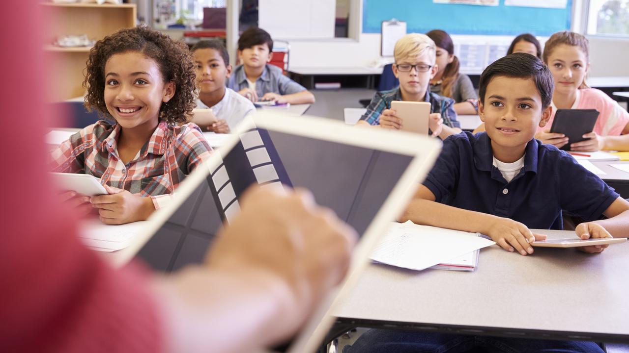 Currently, teachers use paper and pen, a tablet or a laptop to mark the attendance roll. The trial could save teachers time by using technology to check which students are present. Picture: Getty