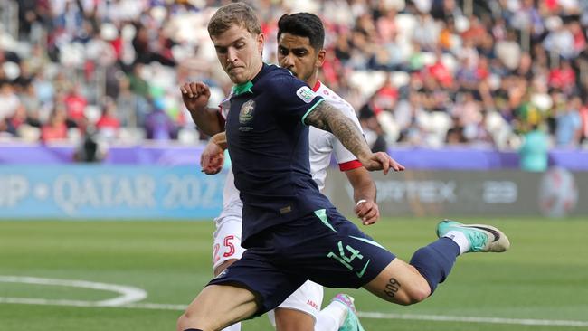 Australia's midfielder #14 Riley McGree prepares to take a shot during the Qatar 2023 AFC Asian Cup Group B football match between Syria and Australia at the Jassim bin Hamad Stadium in Doha on January 18, 2024. (Photo by Giuseppe CACACE / AFP)