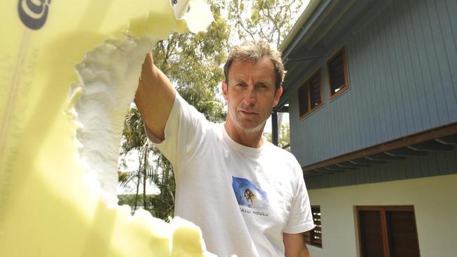 Angourie Surfer Steve King with the surfboard the shark took a bite out of while surfing at back beach Angourie on Sunday morning. Photo: Debrah Novak/The Daily Examiner