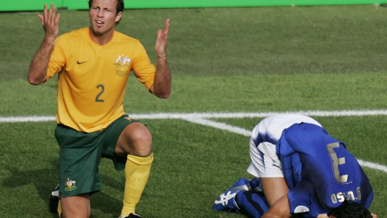 LIBRARY: 26/06/2006 Australia's Lucas Neill, left, reacts after he tackled Italy's Fabio Grosso, right.