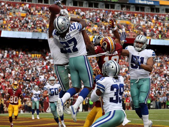 Free safety J.J. Wilcox #27, cornerback Brandon Carr #39, and outside linebacker Kyle Wilber #51 of the Dallas Cowboys break up a pass intended for wide receiver Josh Doctson #18.