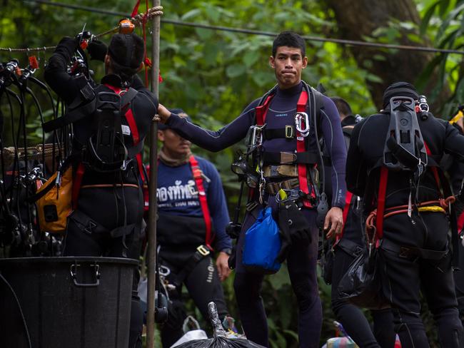 Thai divers carry supplies as rescue operations continue.