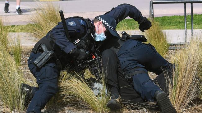 A protester was tackled by police in St Kilda on Saturday. Picture: William West