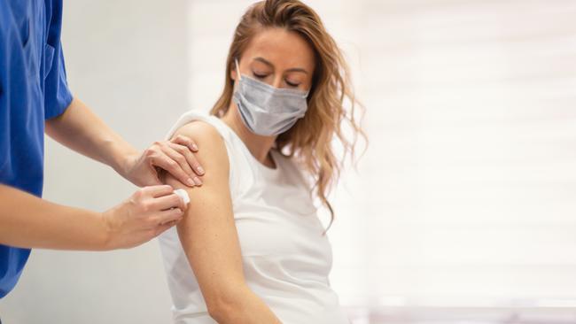 A pregnant woman receives a Covid vaccine.