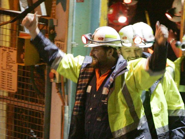 Todd Russell and Brant Webb wave as they emerge from the mine lift. Picture: Ian Waldie