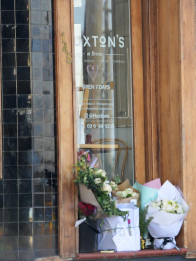 Flowers outside Huxton's cafe on Friday. Picture: Tracey Nearmy