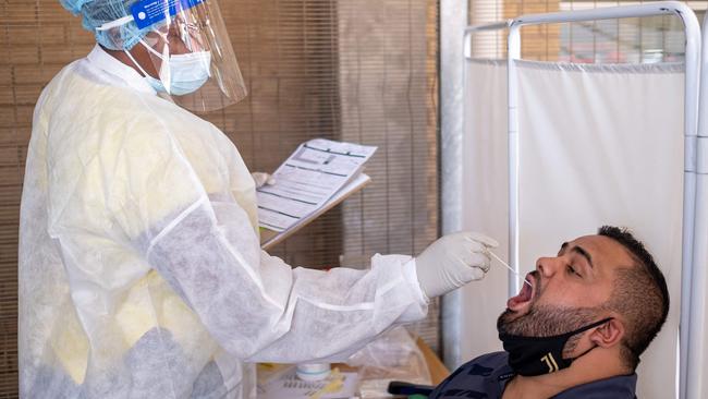 A healthcare worker conducts a PCR Covid-19 test at the Lancet laboratory in Johannesburg on November 30, 2021. - A new, heavily mutated Covid-19 variant, dubbed omicron, spread across the globe on Sunday, shutting borders and renewing curbs as the EU chief said governments faced a 