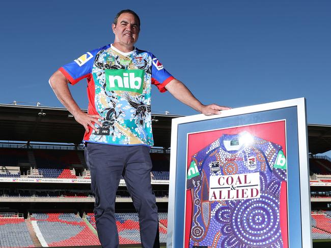 Ashley Gordon with the original Knights indigenous jersey and wearing this year’s that features his family’s totem. Picture: Brett Costello