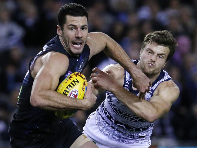 Carlton's Simon White pushes off Geelong's Jordan Murdoch.