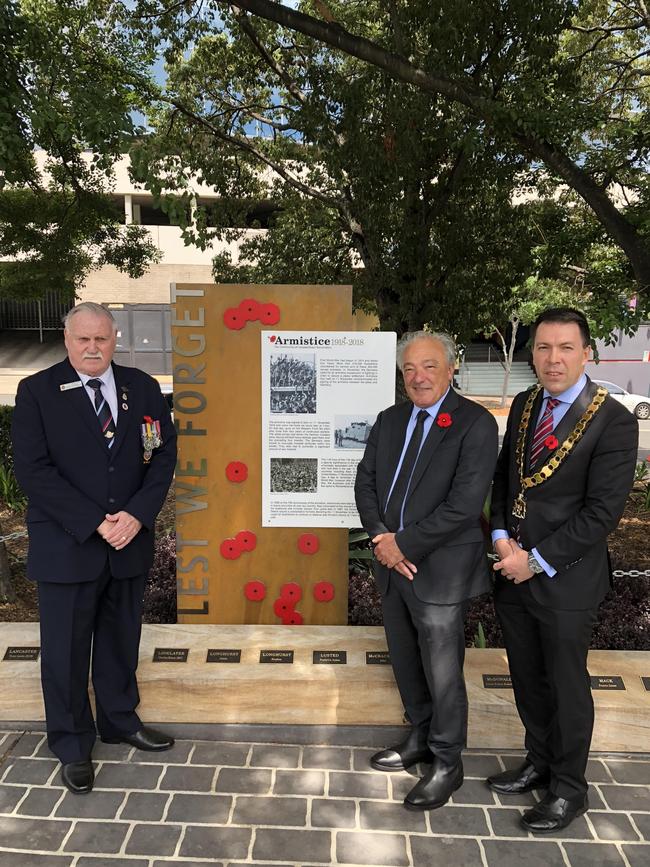 Campbelltown RSl Sub Branch vice president Warren Browning, Dr Freelander and Campbelltown Mayor George Brticevic unveil the memorial in Mawson Park. Picture: Daniel Zautsen