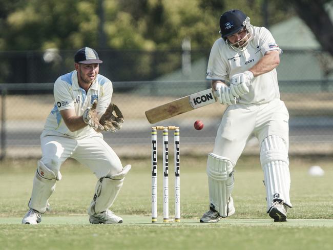 Langwarrin opener Taylor Smith cuts on his way to a patient 49 as Baxter keeper Daniel Lanati looks on. Picture: Valeriu Campan