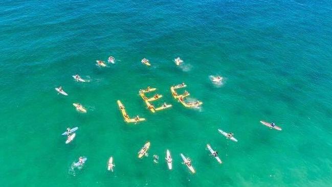 Surf lifesavers paddle out for Lee Bowman.