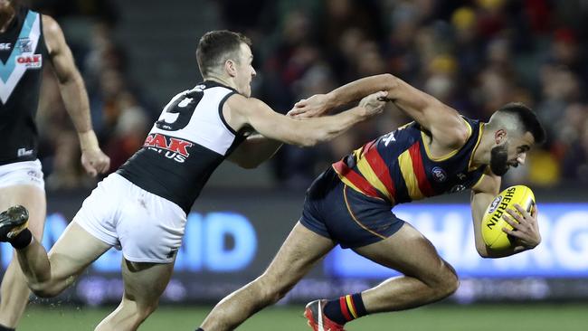 Robbie Gray tries to bring done fleet-footed Crow Wayne Milera. Picture SARAH REED