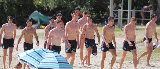 Gold Coast Suns open beach training session at Palm Beach on the Gold coast. Suns players change the rules of training to get the man with the paddle during a paddleboard relay race at Currumbin Creek. Picture Glenn Hampson