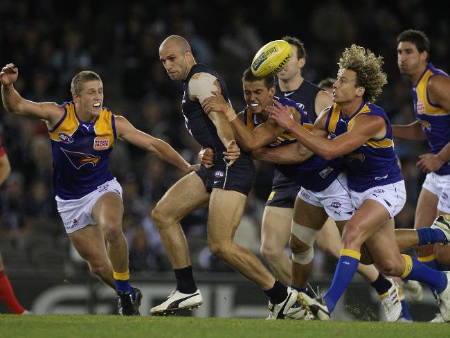 <p>Chris Judd is mobbed by a flock of Eagles at Etihad Stadium.</p>