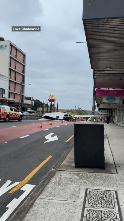 Wind blows roof off shop onto cars