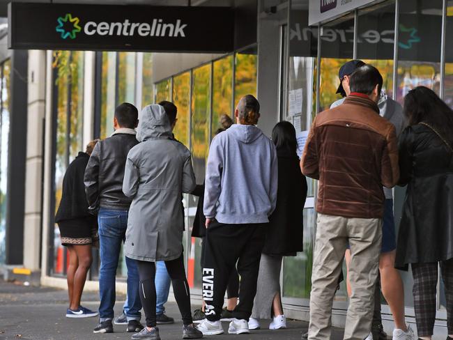 People queue up outside a Centrelink office in Melbourne.