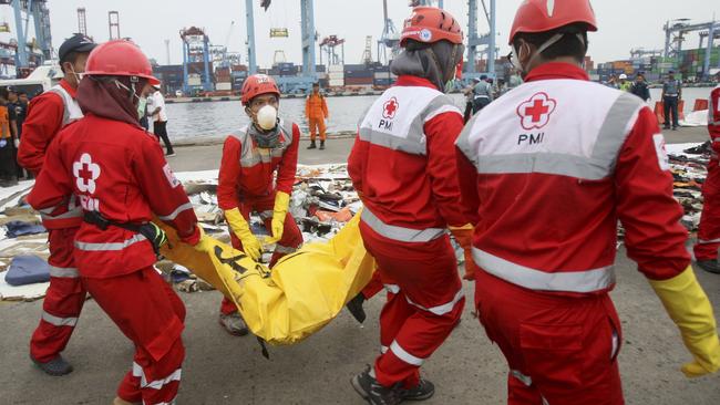 Rescuers carry a body bag containing the remains of victims retrieved from the waters where Lion Air flight JT 610 is believed to have crashed at Tanjung Priok Port in Jakarta.