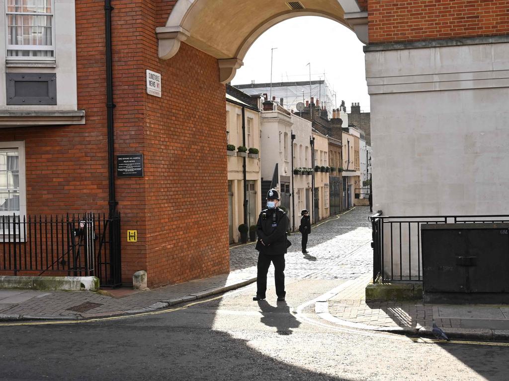 Officers are seen securing one of the mews that lead around the side of King Edward VII's Hospital ion Tuesday. Picture: Glyn Kirk / AFP