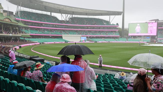 Cricket fans holding out hope that the rain stops so play can resume. Picture: Tim Hunter.