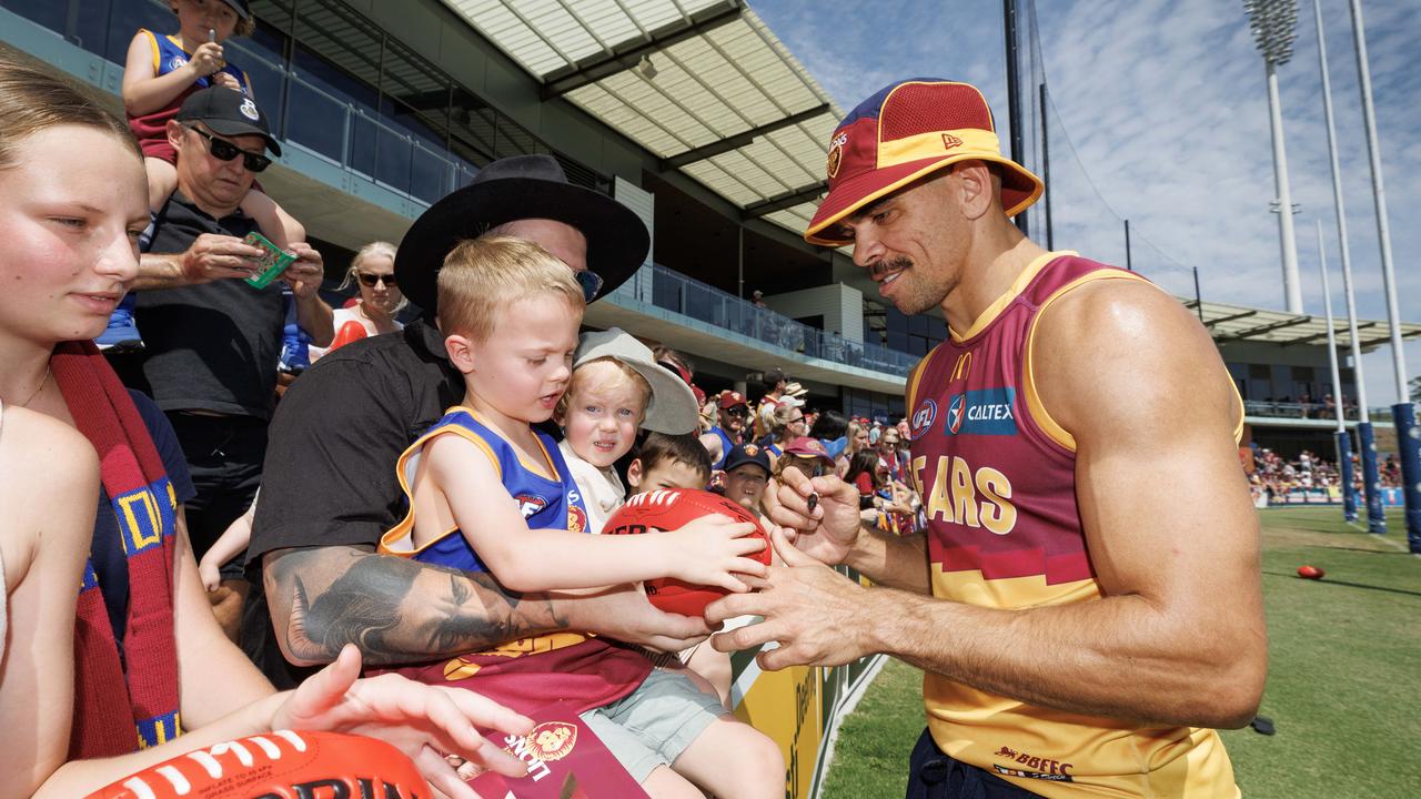 Charlie Cameron signs a footy for five-year-old Hunter Ward. Picture: Lachie Millard