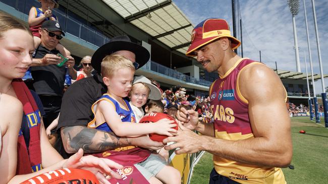 Charlie Cameron signs a footy for five-year-old Hunter Ward. Picture: Lachie Millard