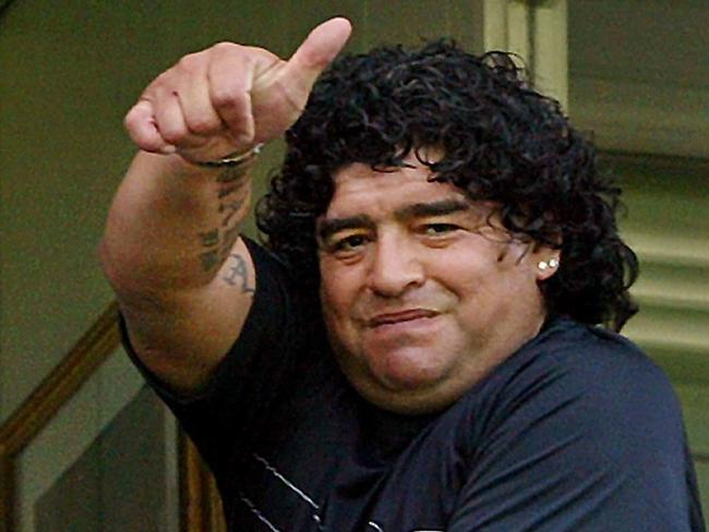 Apr 18 2004. Former soccer star Diego Armando Maradona greets /supporters before the start of a match in Buenos Aires. P/. Sport headshot