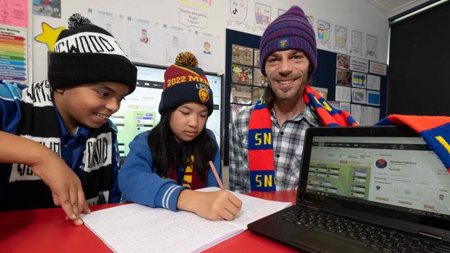 Ryan Kimberley uses SuperCoach to teach maths to year 6 students Pranish Pantha and Grace Nguyen. Picture: Tony Gough