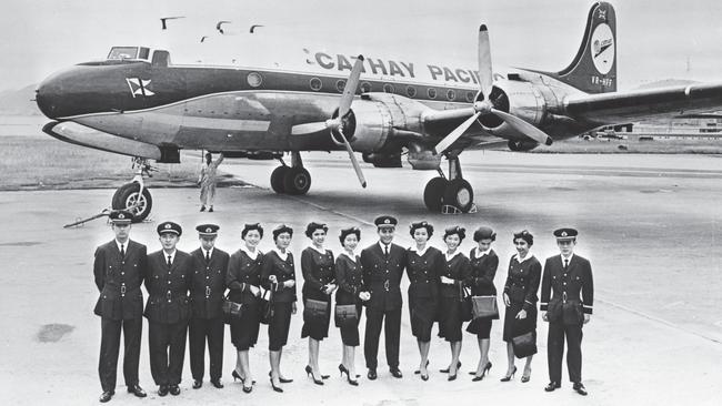 Newly graduated Cathay Pacific cabin crew with a Douglas DC-4, c. 1960.