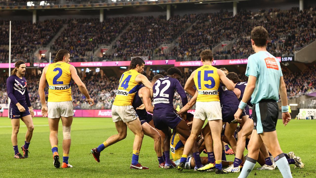 PERTH, AUSTRALIA - AUGUST 13: Players from both teams engage in a melee during the round 22 AFL match between the Fremantle Dockers and the West Coast Eagles at Optus Stadium on August 13, 2022 in Perth, Australia. (Photo by Paul Kane/Getty Images)