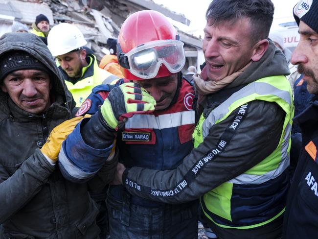 Fireman Erhan Sarac and other rescue team members celebrate each other just after a successful rescue in Elbistan, Turkey. Picture: Getty