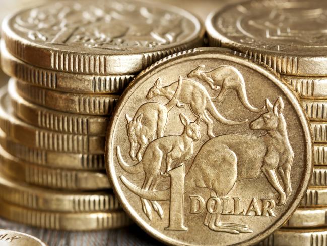 Stacks of Australian one dollar coins. Focus on front coin.