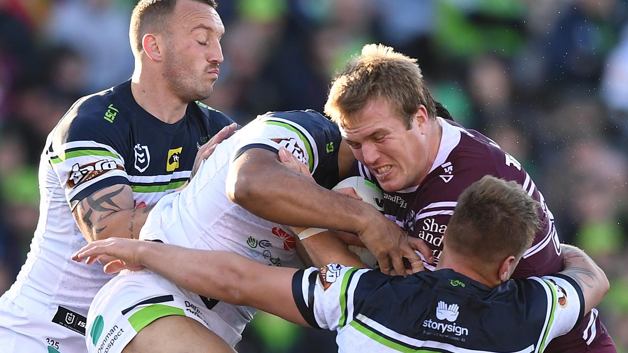 Jake Trbojevic of the Sea Eagles takes on the Raiders defence