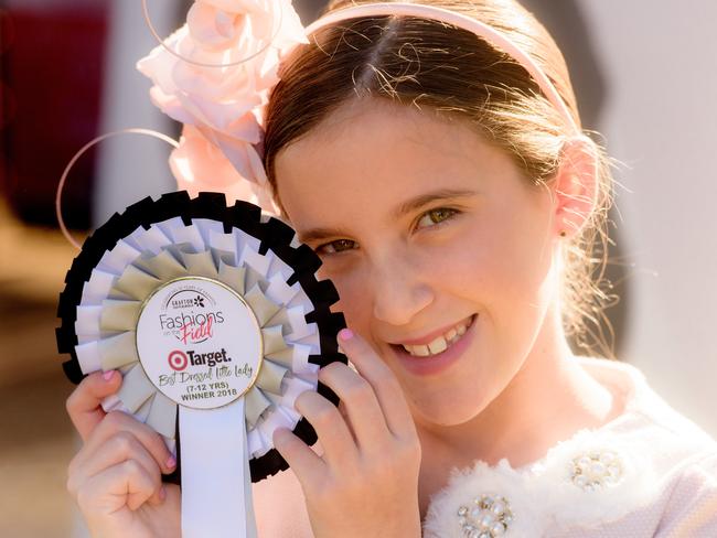 Madison Wilson shows off her winners rosette in the Target best Dressed Little Lady 7-12 years section. Check out all the winners of the Target Kids Fashion on Maclean Cup Day. inside.