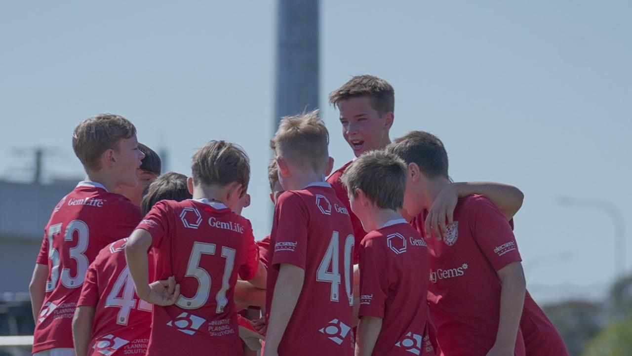 Gold Coast United youth team players celebrate.