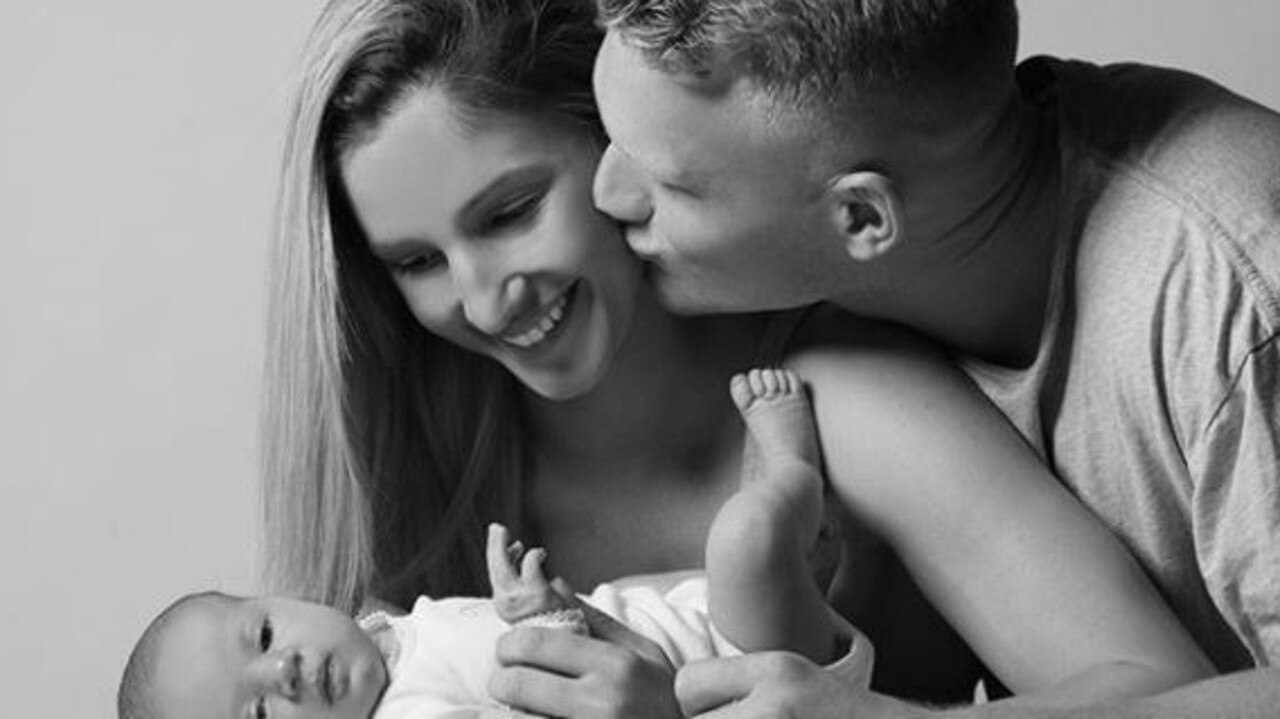 Adam Treloar with fiancee Kim Ravaillion and daughter Georgie.