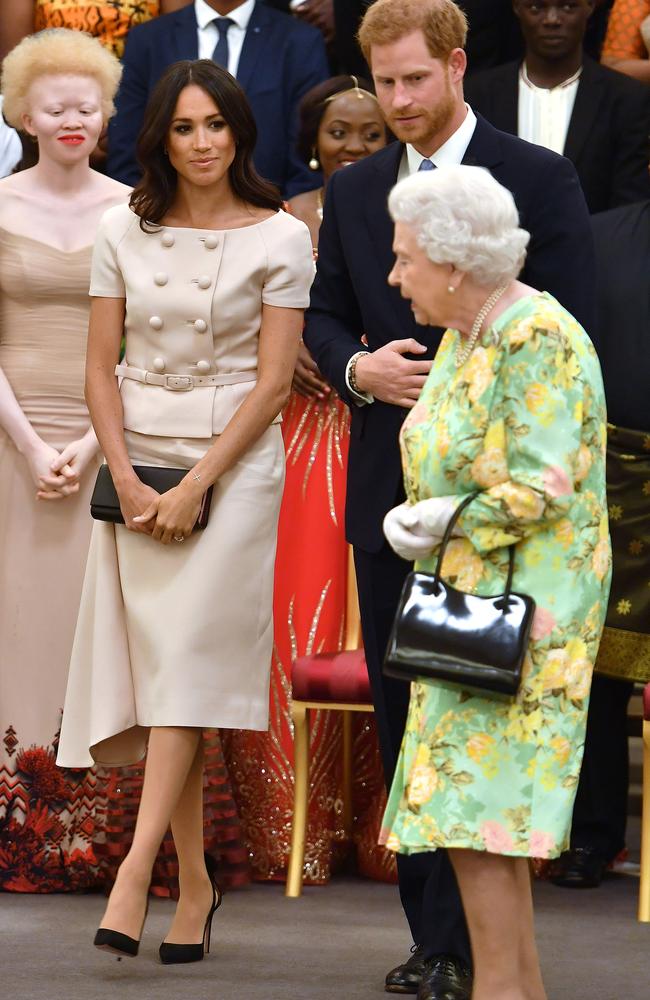 Meghan, Prince Harry and The Queen attend the Queen's Young Leaders Awards Ceremony at Buckingham Palace. Picture: Mega