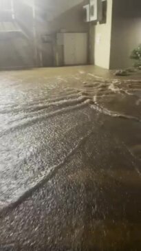 Floodwater gushes through Cairns suburb