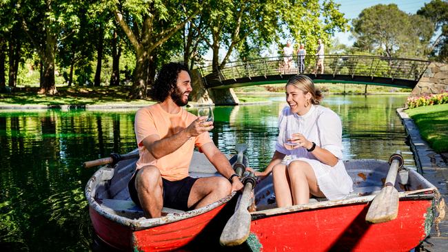 Mark Kamelh of Wine Country and Lizzy Shannon cool off from the hot weather at Refreshment Island, in Rymill Park. Picture: Mike Burton