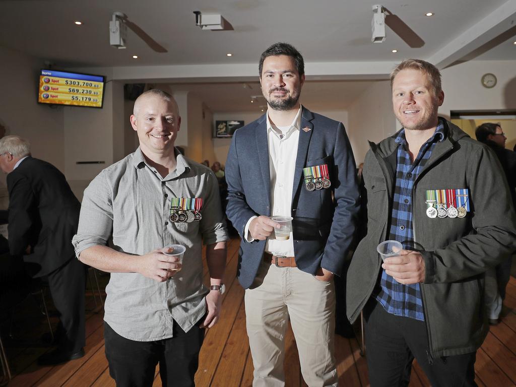 Ex servicemen Daniel McNamara, Emry Thaggard Crocker and Mathew Callaghan enjoy a rum toddy at the Hobart Workers Club Anzac Day breakfast. Picture: PATRICK GEE