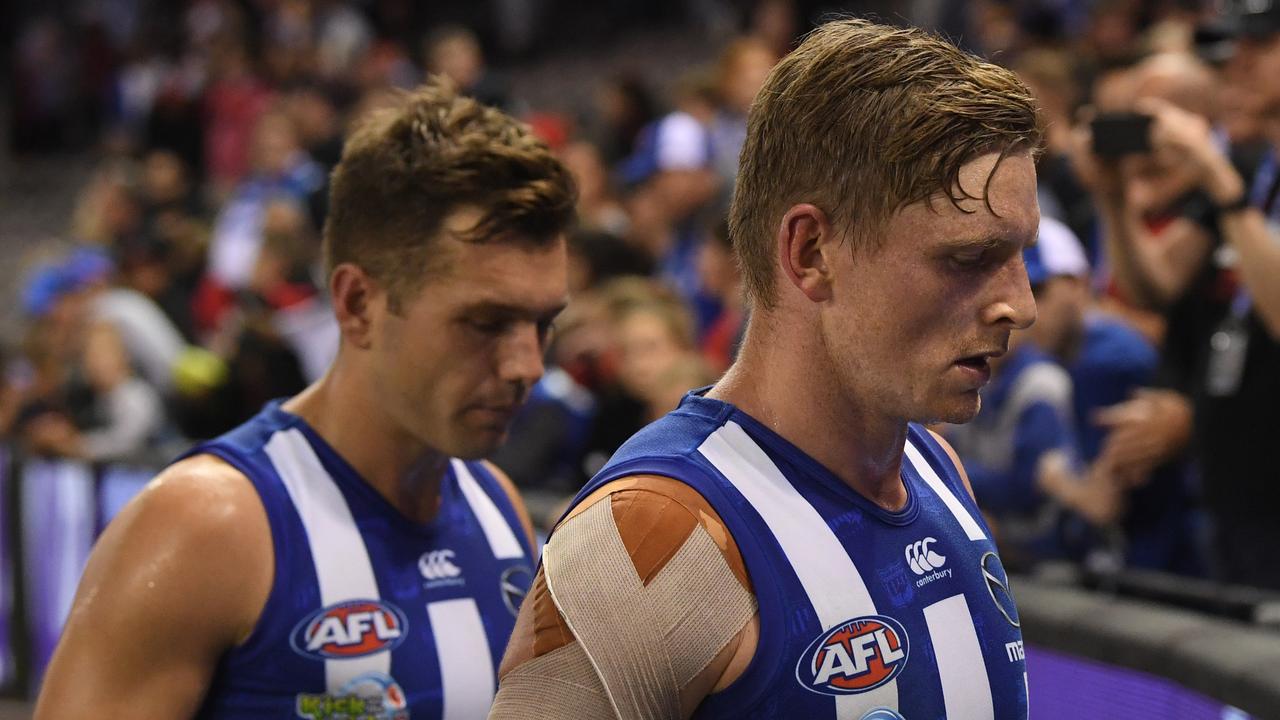 Jack Ziebell (right) and Shaun Higgins leave the ground after North Melbourne’s big loss to Essendon. Photo: Julian Smith/AAP Image. 