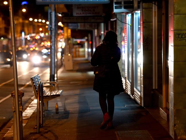 A lone woman walks along the abandoned stretch of footpath in the early hours of last Saturday near the spot where Jill Meagher was murdered. Picture: Mal Fairclough/news.com.au