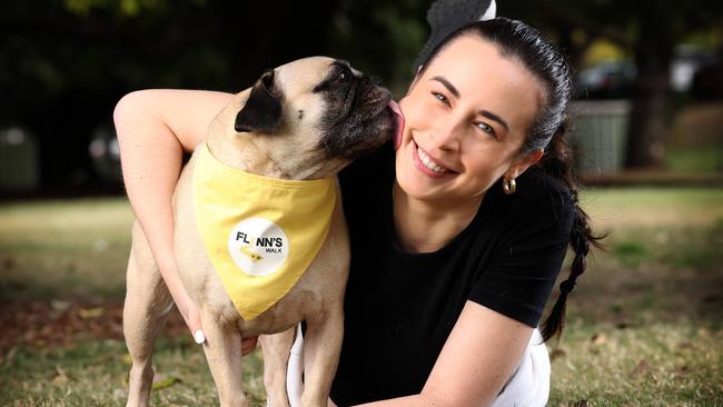 Practice manager at Greencross Vet Teneriffe, Tamisha Franz, 28, of Herston, with her FRAG Charlie, ready for Flynn’s walk in New Farm Park.