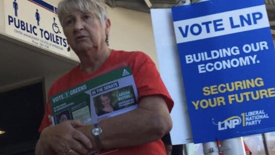 A Labor volunteer is spotted handing out Greens campaign leaflets.