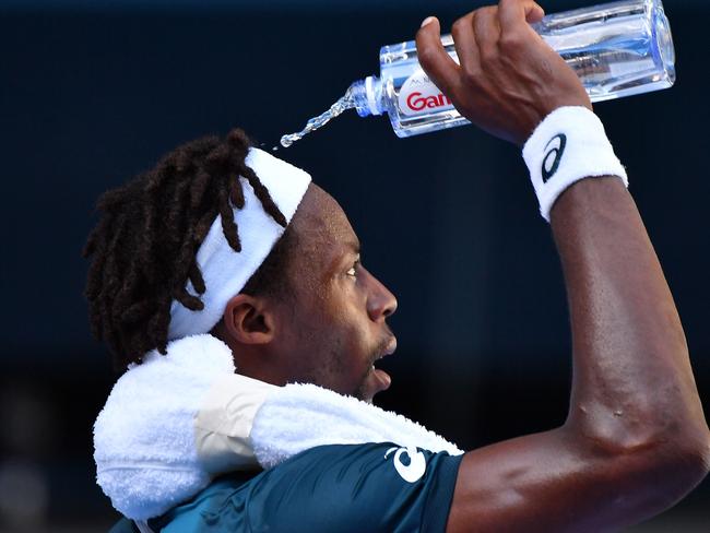 France's Gael Monfils cools off with a bottle of water