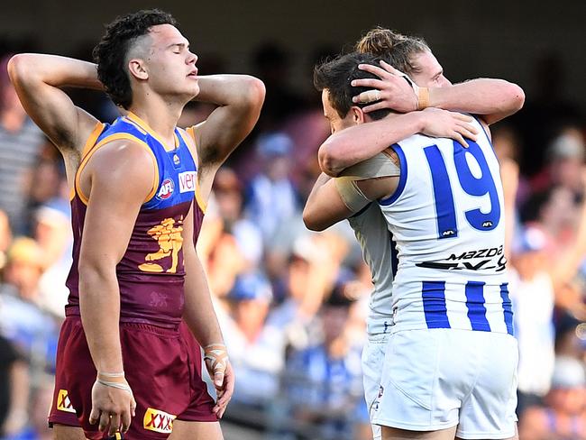 Cameron Rayner of the Lions (left) reacts after the Kangaroos won the Round 20 AFL match between the Brisbane Lions and the North Melbourne Kangaroos at the Gabba in Brisbane, Saturday, August 4, 2018. (AAP Image/Dan Peled) NO ARCHIVING, EDITORIAL USE ONLY