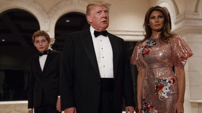 President Donald Trump speaks with reporters as he arrives for a New Year's Eve gala with first lady Melania Trump and their son Barron. Picture: Evan Vucci/AP