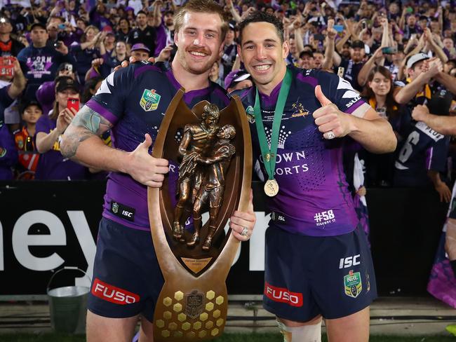 Cameron Munster and Billy Slater pose with the trophy after winning the 2017 Grand Final.